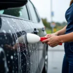 Using a foam brush at a car wash in Auckland