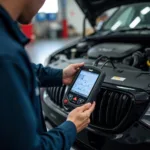 Mechanic in Stafford using a diagnostic tool on a car