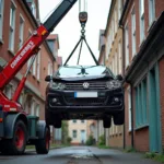 Crane Lifting Damaged Car from Alleyway