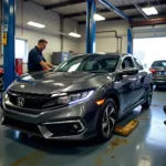 Honda Civic being serviced outside a dealership