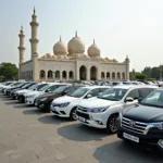 Rental cars parked in front of a mosque in Hyderabad