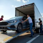 Car Being Loaded onto Transport Truck