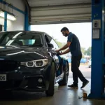 Car being serviced at a garage in India