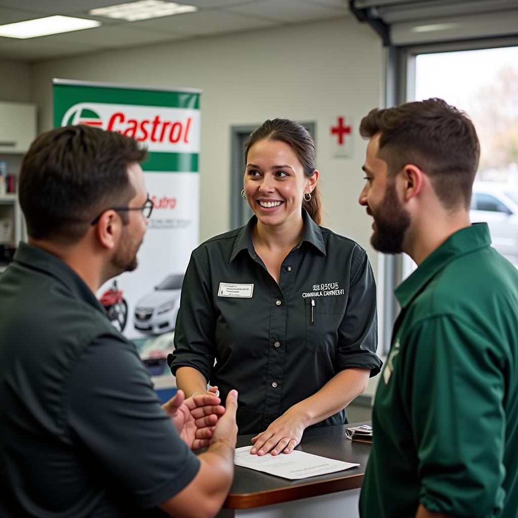 A customer discussing car maintenance with a service advisor at a Castrol service center