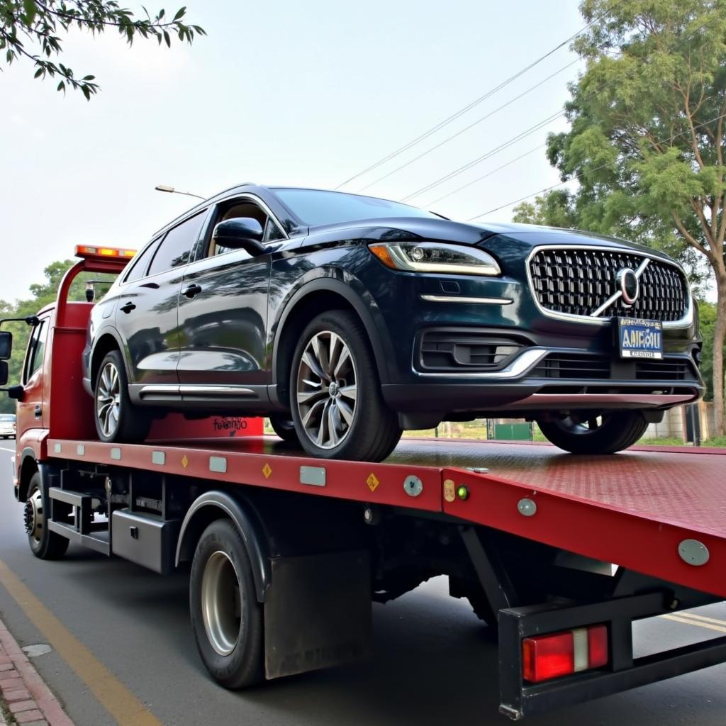 Flatbed tow truck in Ghatkopar loading a luxury car