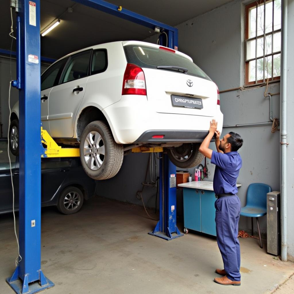 Car undergoing routine maintenance at a Ghatakpukur service center