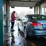 Person Washing Car at Self-Service Station