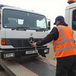 Tow truck operator preparing a vehicle for towing in Panchkula